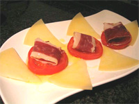 Aperitivo de tomate, jamón y queso